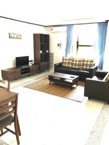 a living room with a couch and a table at Kerteh Apartment in Kertih