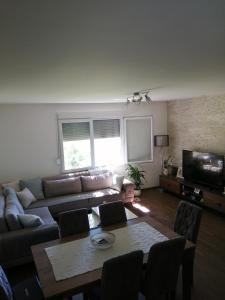a living room with a couch and a table at Vila Ena in Stanišiči