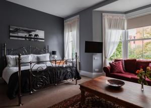 1 dormitorio con 1 cama y 1 sofá en Scotia House - Beautifully Presented Accommodation en Harrogate