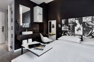 a bedroom with a white bed and a sink at LEGERE EXPRESS Bielefeld in Bielefeld