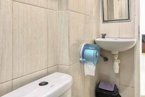 een badkamer met een toilet en een wastafel bij Ancol Homestay in Jakarta