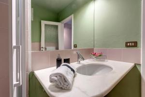 a bathroom with a sink and a mirror at San Niccolò Apartment by Mamo Florence in Florence +11 photos