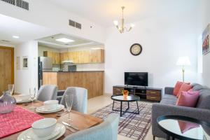 a living room with a couch and a table at Luton Vacation Homes - Dubai Marina, Continental Tower in Dubai