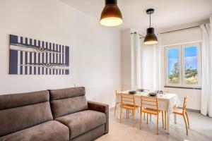 a living room with a couch and a table at Casa Titì by Feeling Italy in Massa Lubrense +28 photos