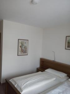 ツヴィーゼルにあるPension Haus Ingeの白い壁の客室内のベッド2台