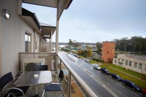 a balcony with a table and a view of a street at Quest Shepparton in Shepparton