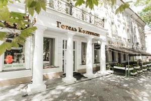 a store front of a white building with columns at Готель Континент Миколаїв in Mykolaiv