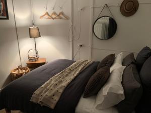 a bedroom with a bed and a mirror on the wall at Evanston Station in Ilfracombe +21 photos