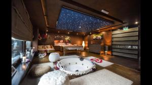 a room with a large tub in the middle of a room at Poiana Brasov Alpin Executive Apartment in Poiana Brasov +23 photos