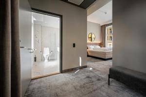 
a hotel room with a bed and a shower at Karl Johan Hotel in Oslo
