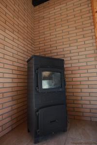 a tv sitting against a brick wall at Lawendowe Zacisze in Trzemeszno Lubuskie
