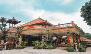 a large building with a roof at Ubud Hotel & Cottages in Malang