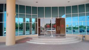 a lobby of a building with a revolving door at Al Massa Hotel in Al Ain
