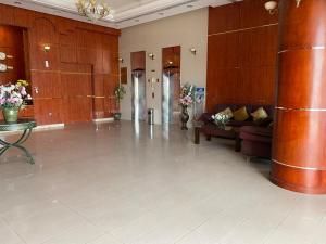 a lobby with a couch and a table in a building at Al Massa Hotel in Al Ain