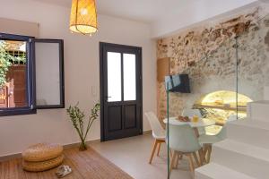 a living room with a table and chairs and a window at Orestis downtown home in Rethymno Town