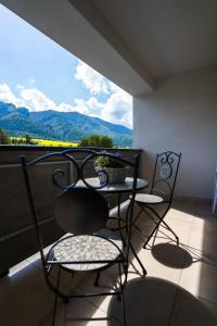 a balcony with two chairs and a table with a view at Luxury Mountain View Apartment in Terchová
