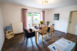 a dining room with a table and chairs at Luxury Mountain View Apartment in Terchová