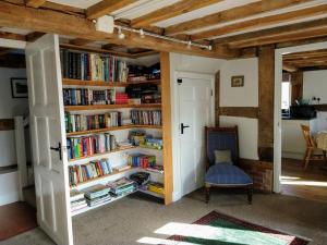 a room with a book shelf filled with books at Little Drift in Edgton