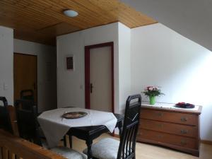 a dining room with a table and chairs and a dresser at Ferienwohnung Maidenhain in Tießau