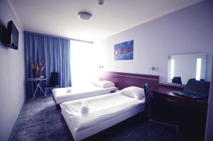 Pokój hotelowy z 2 łóżkami i biurkiem w obiekcie Hotel Śląsk we Wrocławiu