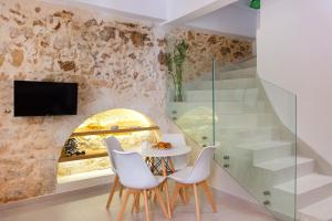 a dining room with a table and chairs and a window at Orestis downtown home in Rethymno