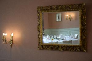 a room with a mirror, a sink, and a table at Hotel Rheinfels in Stein am Rhein