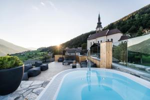 a swimming pool on the roof of a house at Viel Nois Guest House in Funes