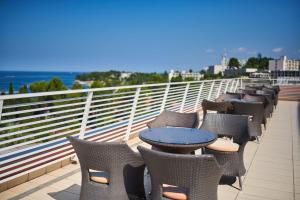 a row of chairs and tables on a balcony at Hotel Albatros Plava Laguna in Poreč