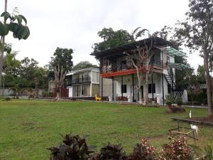 une maison avec une pelouse devant elle dans l'établissement ปอ อา ยอ รีสอร์ท, à Pai