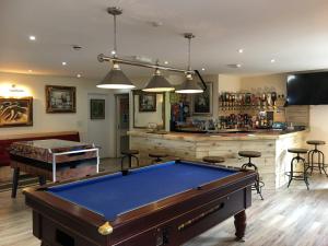 a billiard room with a pool table and a bar at The Quies in Newquay