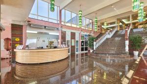 a shopping mall with a spiral staircase in a building at Hotel Istra Plava Laguna in Poreč