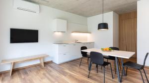 a kitchen and dining room with a table and chairs at SOLeARIA residence in Riva del Garda
