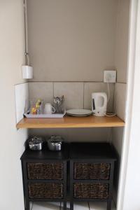 a kitchen with a sink and a counter with baskets at Honey Lodge in Klipdrift