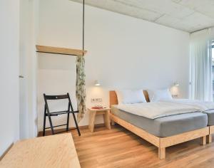 1 dormitorio con 1 cama y 1 silla en SOLeARIA residence en Riva del Garda