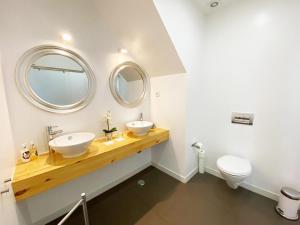 a bathroom with two sinks and a mirror at The Postcard Lisbon in Lisbon