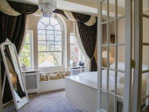 a bedroom with a bed and a large window at WILDES Derbyshire in Chesterfield