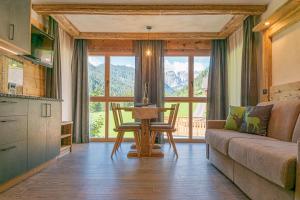 a living room with a couch and a table at Lüch dl Jëinder in San Martino in Badia