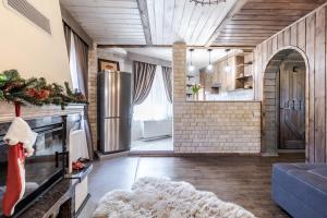 a kitchen and living room with a refrigerator at Маєток "ZYMON & SKI" in Bukovel