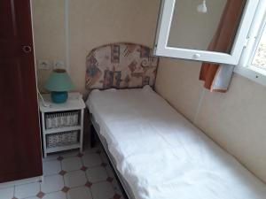 a small bedroom with a bed and a window at Mobil Home Fradin Parc de loisirs in Talmont