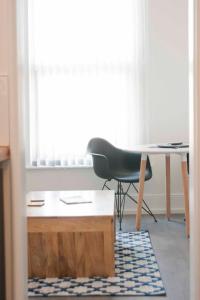 a desk and a chair in a room with a window at Chandos Apartments in Broadstairs