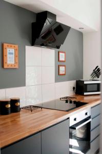 a kitchen with a counter with a stove top oven at Chandos Apartments in Broadstairs