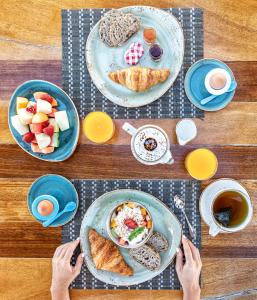a wooden table with plates of food on it at Casa Munich in Ses Salines