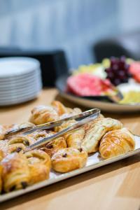 a tray of pastries on a wooden table at Holiday Inn Brentwood, an IHG Hotel in Brentwood