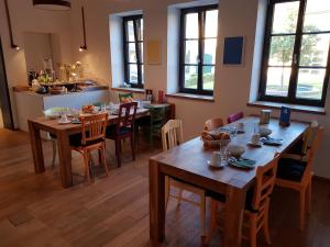 a dining room with wooden tables and chairs at Herberge Hof Armada in Wiesbaden