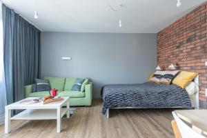 1 dormitorio con cama y pared de ladrillo en Murano Art Home en Varsovia