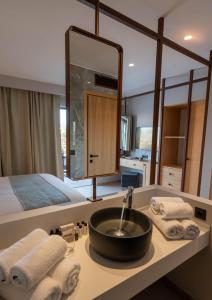 a bathroom with a sink and a large mirror at Stella Palace Aqua Park Resort in Hersonissos