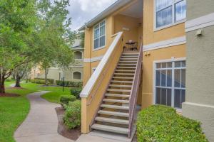 a house with stairs leading up to a porch at WFH Away from Home! FREE Wi-Fi and Parking, 4mi to Clearwater Beach in Clearwater