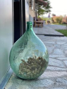 a green glass vase sitting on a sidewalk at Allegro Holiday in Nizza Monferrato