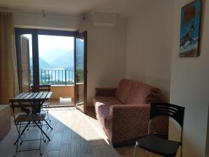 a living room with a couch and a table and a balcony at Lago Vivo in Barrea