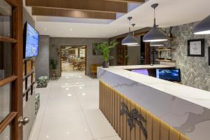 a lobby of a restaurant with a reception counter at The Cycad Lodge & Chalets in Nelspruit